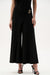 Woman wearing designer wide leg pants for chic outfit styling