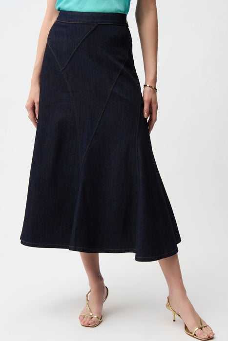 Woman wearing dark blue denim midi flared jean skirt with patchwork seams from Joseph Ribkoff