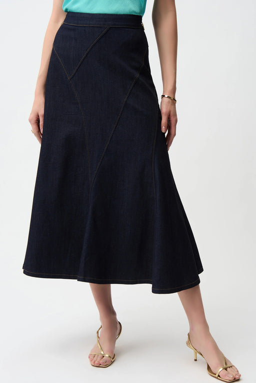 Woman wearing dark blue denim midi flared jean skirt with patchwork seams from Joseph Ribkoff
