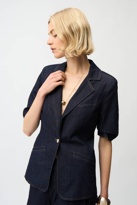 Woman wearing dark blue denim blazer jacket in dark wash with front pockets and puff sleeves from Joseph Ribkoff