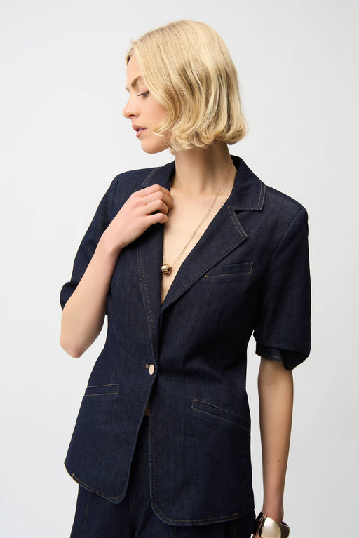 Woman wearing dark blue denim blazer jacket in dark wash with front pockets and puff sleeves from Joseph Ribkoff