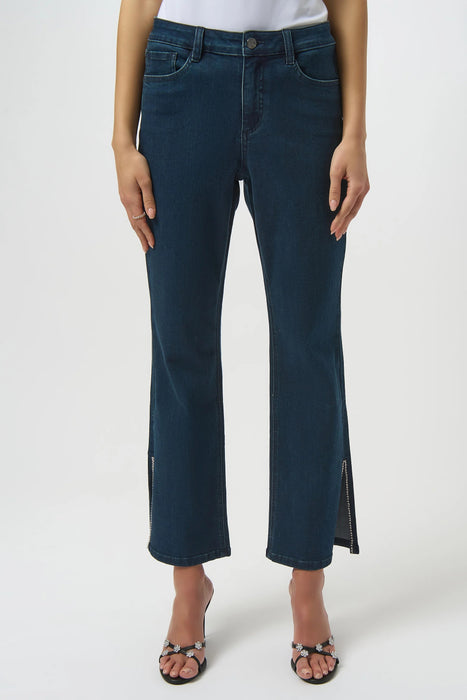 Woman wearing a dark blue denim straight jean with rhinestone-trimmed side split hem
