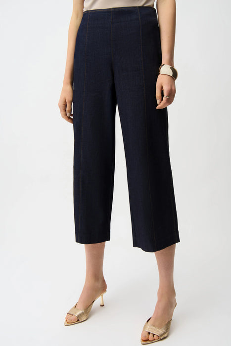 Woman wearing a dark blue jeans in dark wash denim with cropped wide leg from Joseph Ribkoff