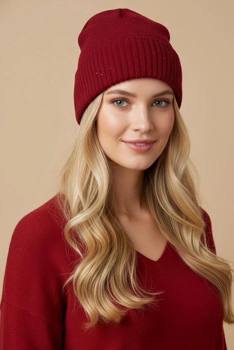 Woman wearing red sequined knitted beanie from Joseph Ribkoff