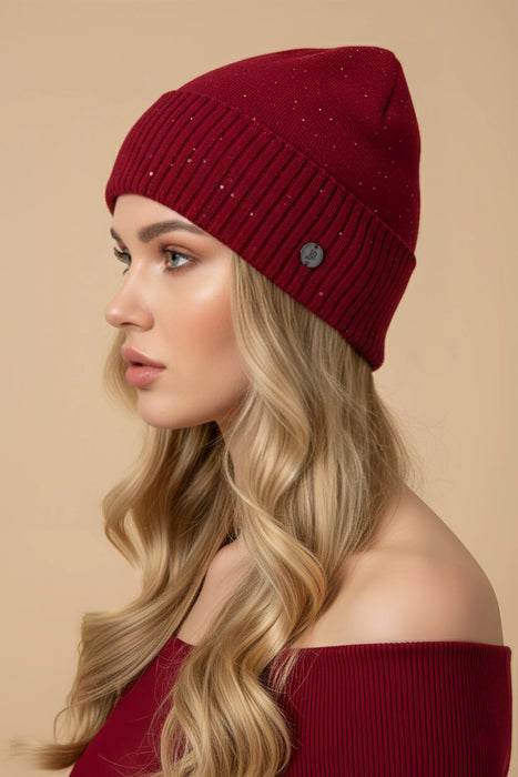 Woman wearing red sequined knitted beanie from Joseph Ribkoff