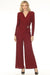 Woman wearing a red shimmery one piece jumpsuit with wrap bodice and wide leg from Joseph Ribkoff