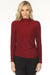 Woman wearing a shimmery red fitted top with mock neck and ruching at the side from Joseph Ribkoff