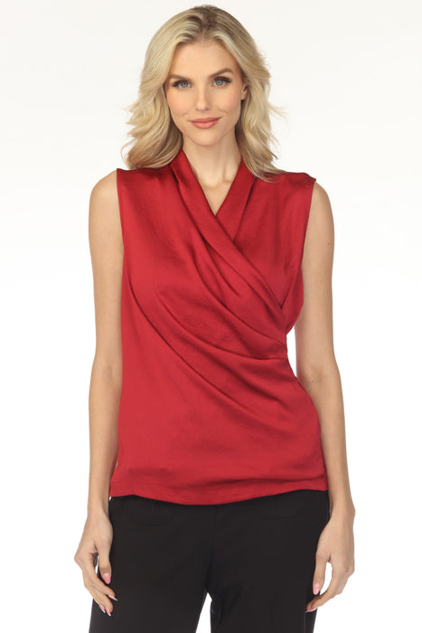 Woman wearing a sleeveless red top with a draped wrap neck design from Joseph Ribkoff