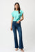 Woman wearing a medium wash blue denim jeans with front patch pockets and flared leg from Joseph Ribkoff