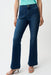 Woman wearing a medium wash blue denim jeans with front patch pockets and flared leg from Joseph Ribkoff