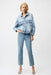 Woman wearing Joseph Ribkoff denim oversized jacket with pearls and studs, featuring embellished light-wash denim, relaxed fit, classic collar, and statement detailing.
