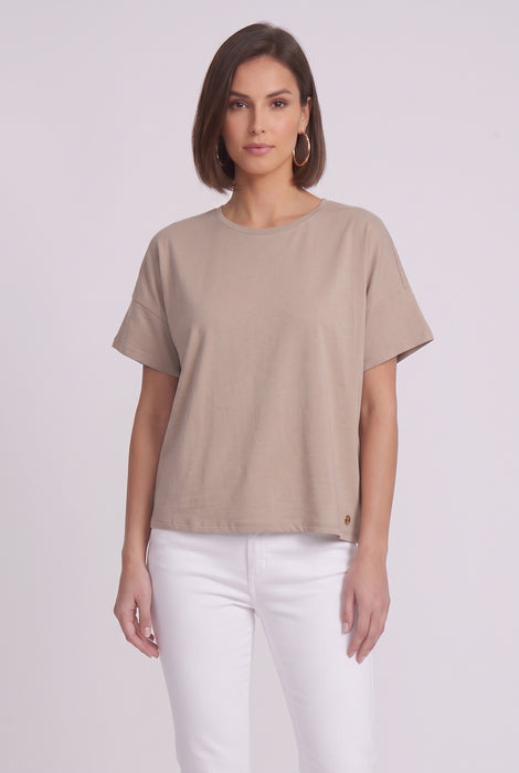 A woman modeling a short-sleeve, crew-neck taupe-beige top from Joseph Ribkoff