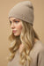 Woman wearing beige sequined knitted beanie from Joseph Ribkoff