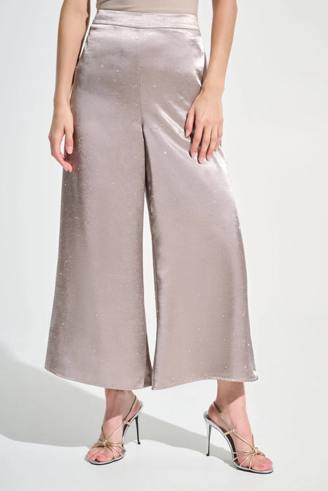 Woman wearing a gray satin wide leg pants with rhinestone embellishments and pull on high waist from Joseph Ribkoff