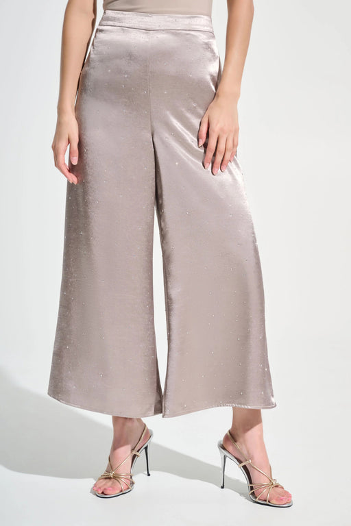 Woman wearing a gray satin wide leg pants with rhinestone embellishments and pull on high waist from Joseph Ribkoff