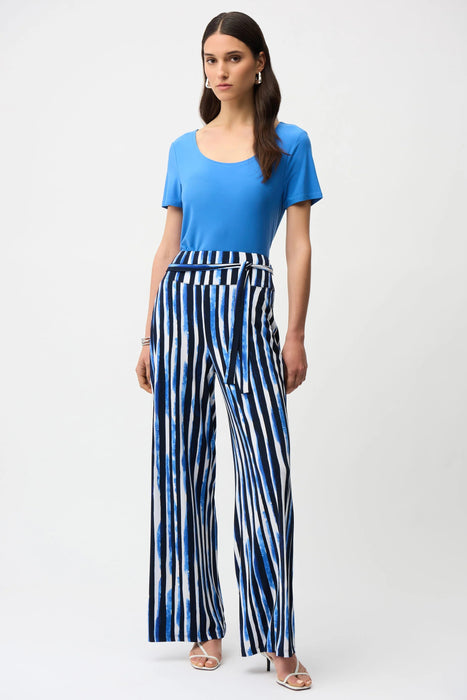 Woman wearing Joseph Ribkoff fit and flare short sleeve top, featuring a flattering silhouette, soft stretch fabric, and elegant minimalist design for versatile styling.
