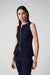 Woman wearing a fitted sleeveless vest with front zipper and tailored silhouette, paired with matching trousers.