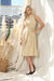 Woman modeling Joseph Ribkoff midi dress with side pockets for wedding guest outfit