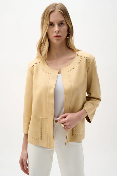 Woman wearing a beige studded faux suede jacket with open front and front pockets from Joseph Ribkoff