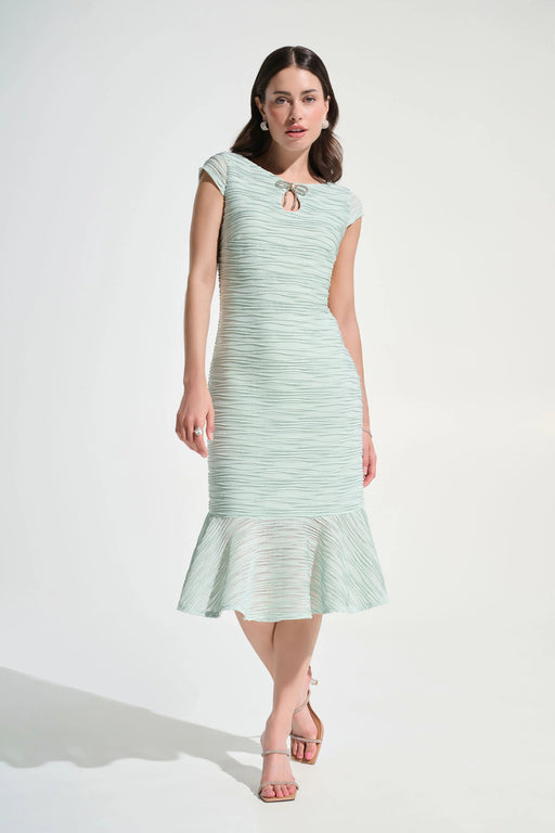 Woman wearing an elegant flounce dress with rhinestone bow detail, styled for a formal evening or special occasion look
