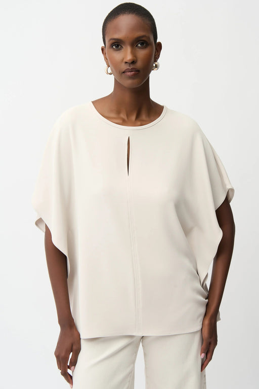 Woman wearing Joseph Ribkoff front keyhole poncho top styled for elegant casual wear, office chic, resort vacation, and evening dinner occasions.