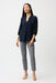Woman wearing Joseph Ribkoff geometric print pull-on slim fit pants, featuring a modern patterned design, cropped length, and flattering stretch fit for chic styling.