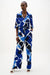 Woman wearing Joseph Ribkoff blue an white geometric print wide leg pull-on pants 262155, featuring a bold pattern, flowy silhouette, elastic waistband, and a flattering modern fit.