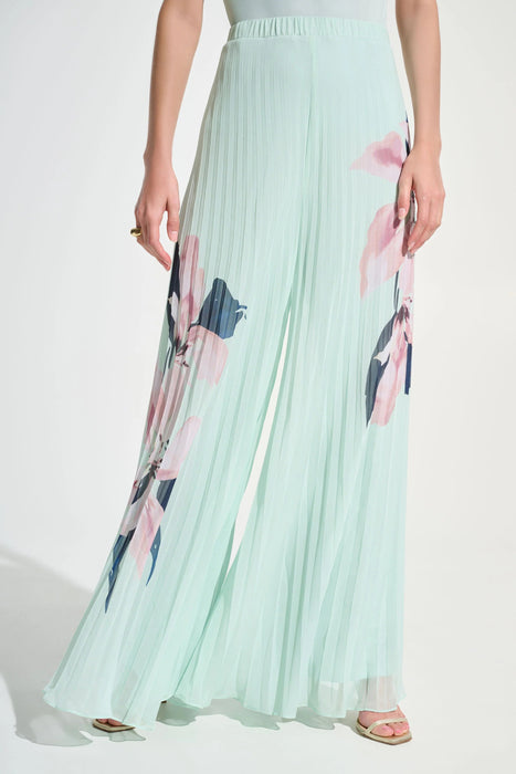 Woman wearing Joseph Ribkoff green/multi floral chiffon wide-leg pleated pants styled for resort vacation, summer events, evening dinners, and formal occasions.