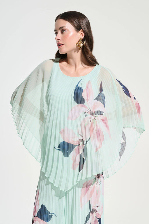 Woman wearing Joseph Ribkoff chiffon floral print poncho top styled for resort wear, special occasions, weddings, and elegant evening outfits.