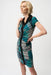 Woman wearing a green and black geometric striped sheath dress with zip front and cap sleeves from Joseph Ribkoff