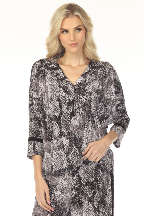 Woman wearing a snakeskin patterned top with collared v-neck and 3/4 sleeves from Joseph Ribkoff