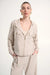 Woman wearing a hooded boxy utility jacket with a zip-front design, flap pockets, and relaxed fit for a modern casual look.