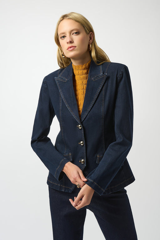 Woman wearing a dark wash denim fitted blazer jacket with long sleeves