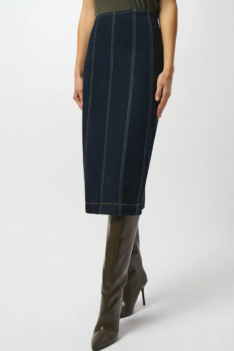Woman wearing a dark denim jean midi skirt with vertical stitch details