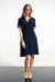 Woman in a navy polo dress with striped trim at the v-neck and short sleeves from Joseph Ribkoff