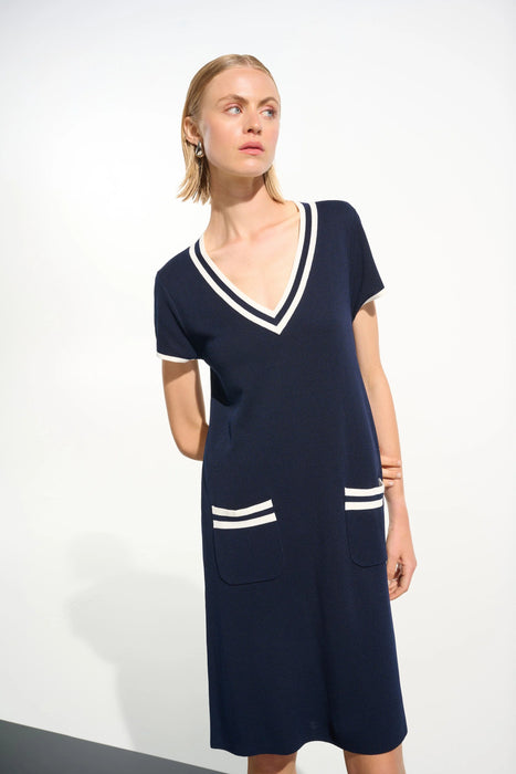 Woman wearing a Joseph Ribkoff A-line dress with striped rib-trim V-neckline and front patch pockets, styled for casual outings, travel, or chic everyday wear.