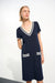 Woman wearing a Joseph Ribkoff A-line dress with striped rib-trim V-neckline and front patch pockets, styled for casual outings, travel, or chic everyday wear.