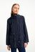 Woman wearing a navy blue anorak jacket with hidden hood and drawstring waist from Joseph RIbkoff