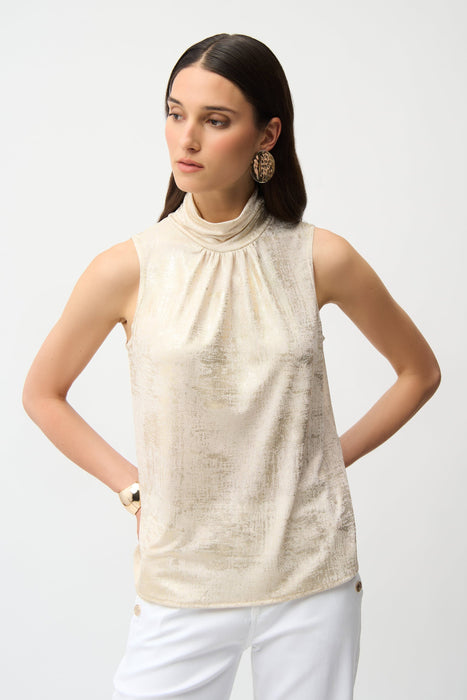 Woman wearing ivory sleeveless top with gold metallic sheen and mock neck from Joseph Ribkoff