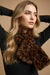 Woman wearing a leopard print faux fur scarf from Joseph Ribkoff