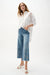 Woman wearing Joseph Ribkoff embroidery wide leg crop jeans, featuring light-wash denim, floral cutout embroidery, cropped length, and a relaxed modern fit.