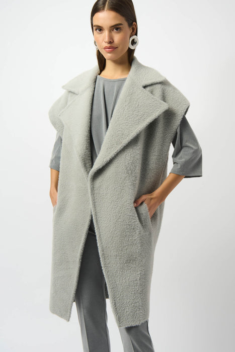 Woman wearing a light gray feather yarn boxy sweater vest from Joseph Ribkoff
