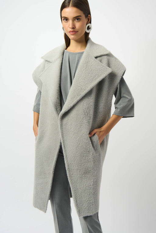 Woman wearing a light gray feather yarn boxy sweater vest from Joseph Ribkoff