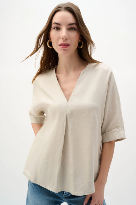 Woman wearing Joseph Ribkoff linen straight top with V-notch neckline styled for office casual, summer outings, resort wear, and elegant everyday looks.
