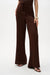 Woman wearing Joseph Ribkoff drawstring wide leg satin pants for elegant resort outfit