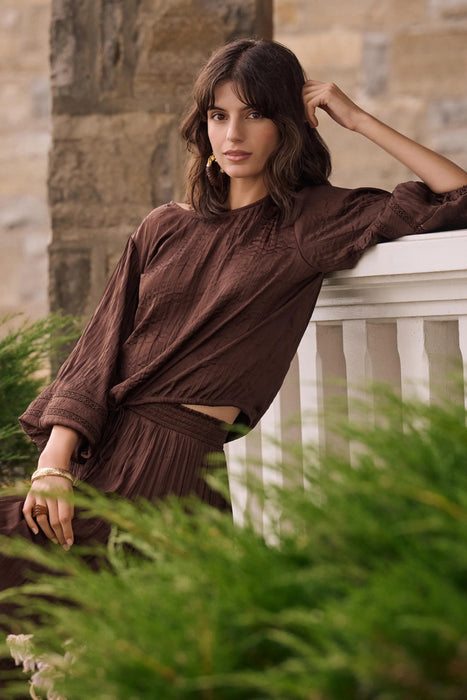 Woman wearing Joseph Ribkoff mahogany pleated satin cocoon top styled for evening wear, special occasions, and elegant modern outfits.
