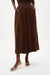 Woman wearing a brown Joseph Ribkoff pull-on culotte pants with pleats, featuring flowy wide-leg silhouette, cropped length, and a flattering high-rise modern fit.