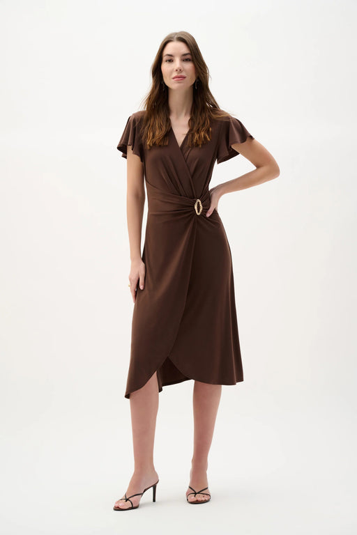 Woman wearing a mahogany wrap dress with ruffled sleeves and gold buckle detail, styled in an elegant midi silhouette for a sophisticated look