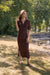 Woman wearing a brown midi sweater knit dress with short sleeves from Joseph Ribkoff