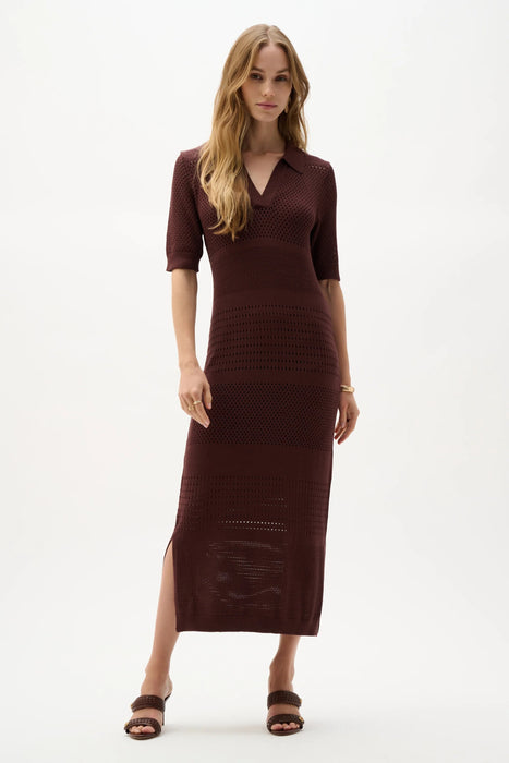 Woman wearing a mahogany viscose sweater knit straight midi dress with short sleeves, V-neck collar, and side slit detail.